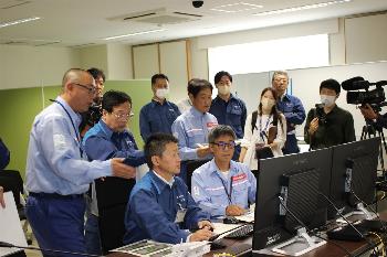 遠隔操作画面を見ながら指示を出す田中市長の写真