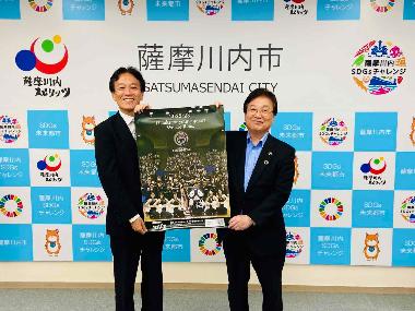 鹿児島レブナイズ有川COOと田中市長がポスターを手に写る写真
